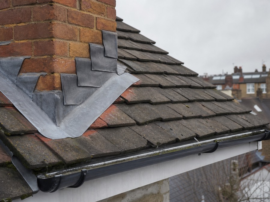 Roof tiles, chimney flashing and guttering on a London home